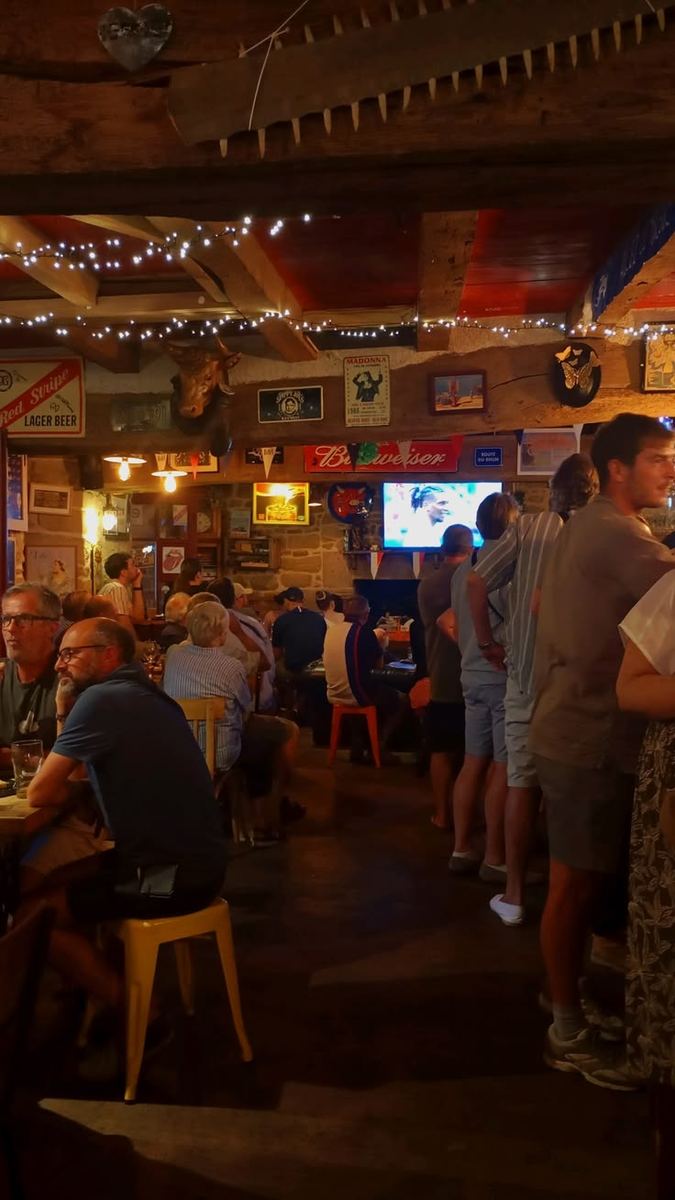 Travellers and locals watching the game together in a cosy pub